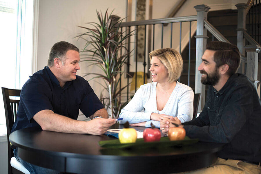 Young couple getting a quote on windows and doors from a window salesman