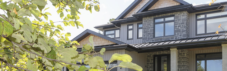 Luxury home with black, vinyl replacement windows.